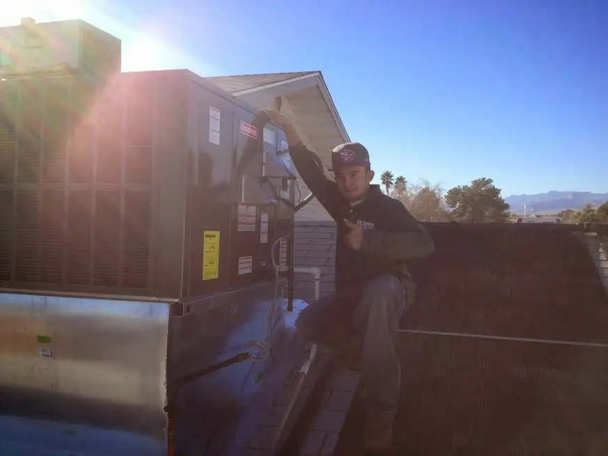 HVAC technician performing HVAC Inspection on a rooftop unit in Princeton